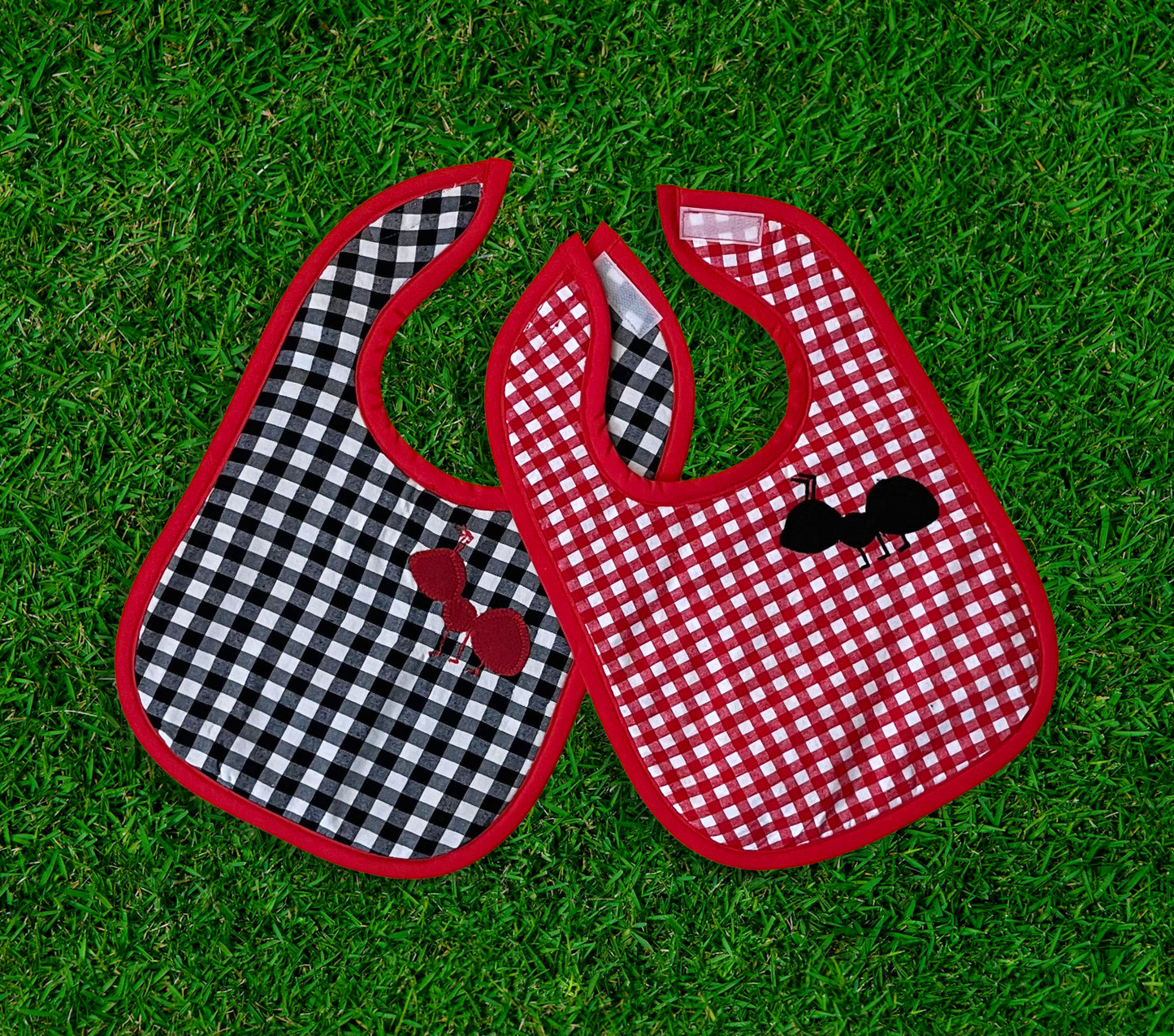 red, white, and black gingham bib with appliqued and embroidered ant