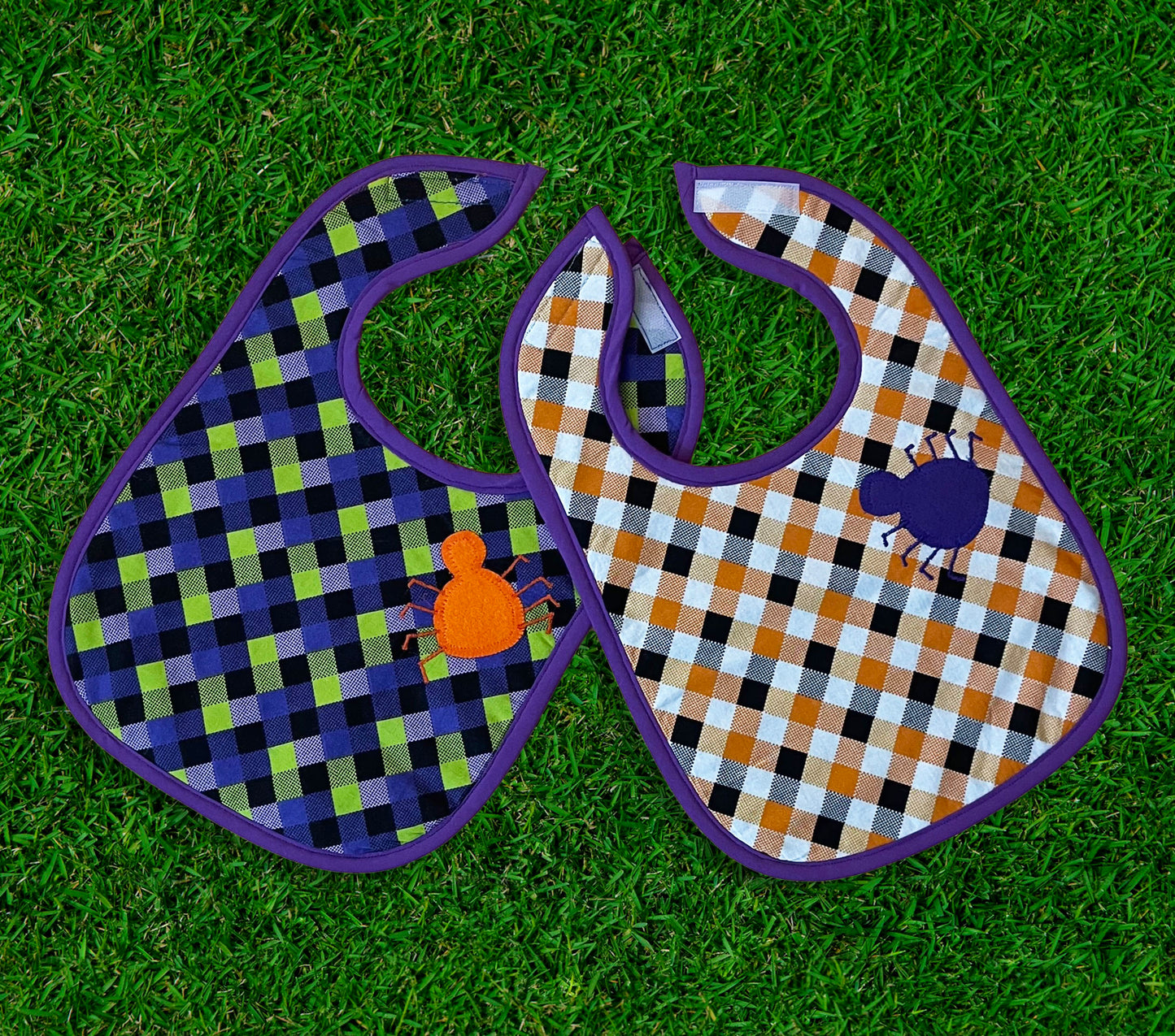 orange, green, purple, and black gingham halloween bibs with applique and embroidered spiders