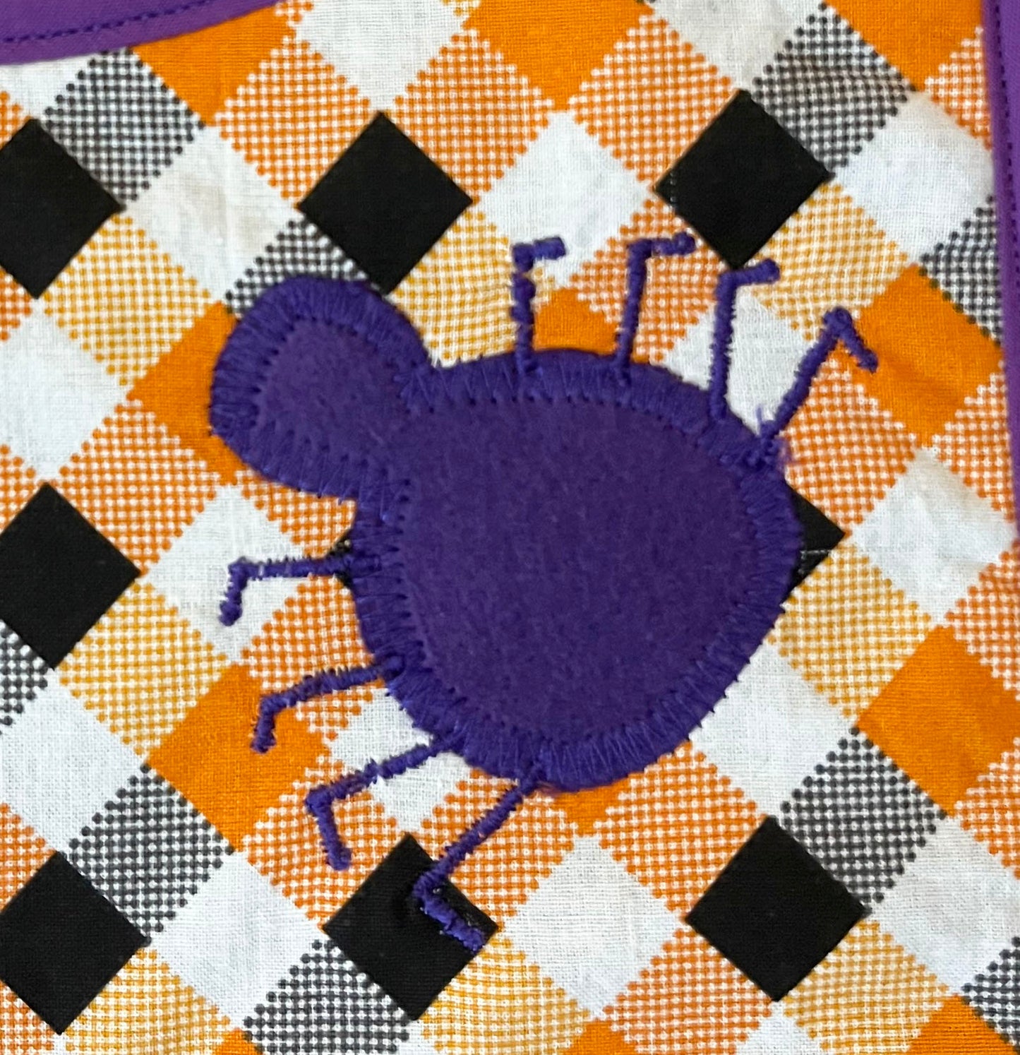 spider embroidered bib